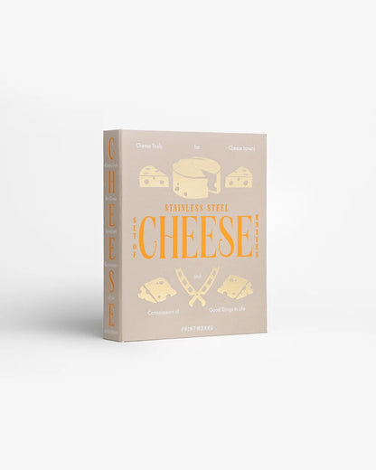 Scatola chiusa: Scatola a libro beige Printworks Cheese Tools con scritta arancione e illustrazioni di formaggi